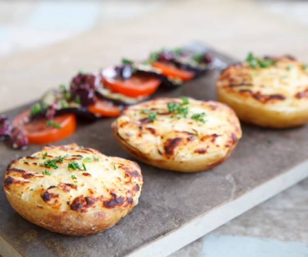 Cheesy potatoes with black olive, tomato & aubergine salad